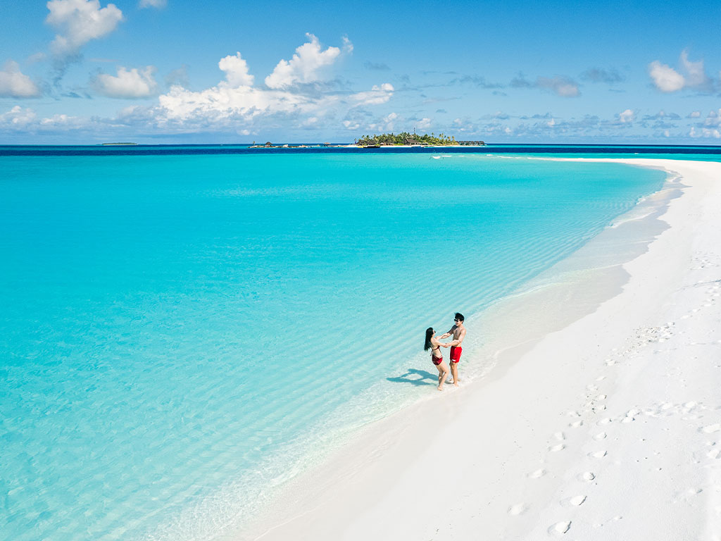 couple-enjoying-joyful-laugh-beach-maldives-sandbank